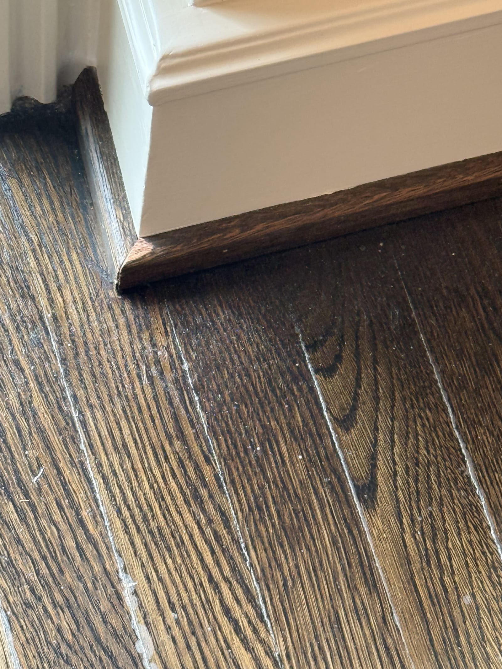 Dark refinish against fresh baseboard